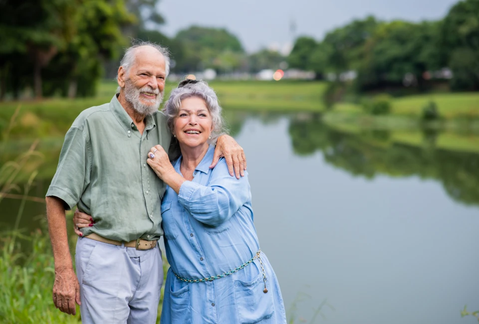 elderly-couple-hugging-river